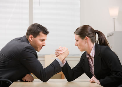 Co-workers aggressively arm wrestling for dominance
